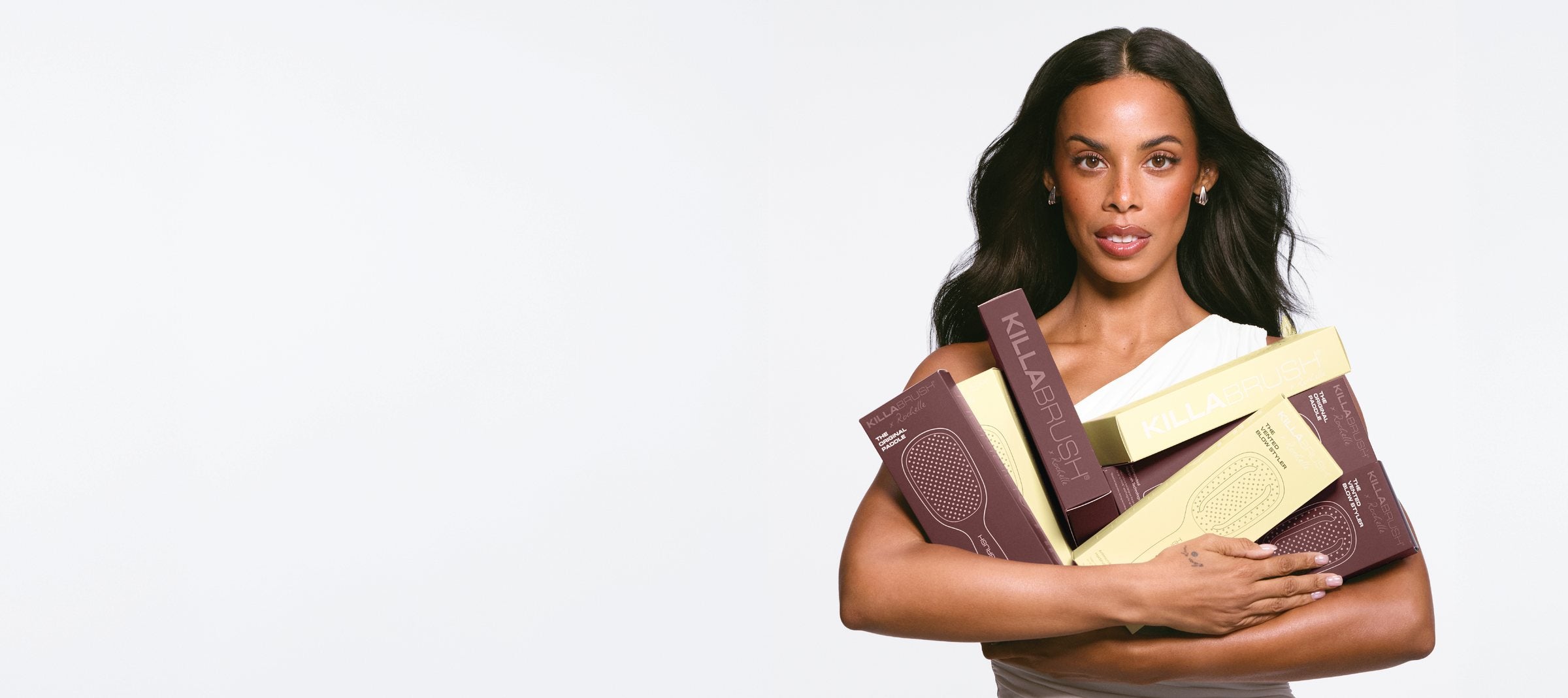 Rochelle Humes holding KILLABRUSH x Rochelle boxes in Butter and Merlot